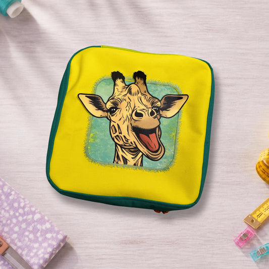 Pencil case "Boundless" in yellow and teal from above – giraffe panel with ears and horns sticking out